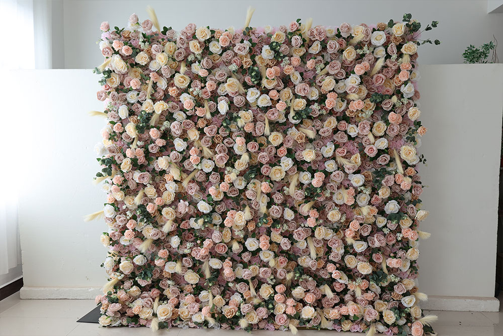 luxurious flower wall backdrop with peach, cream, and blush blooms with green foliage.