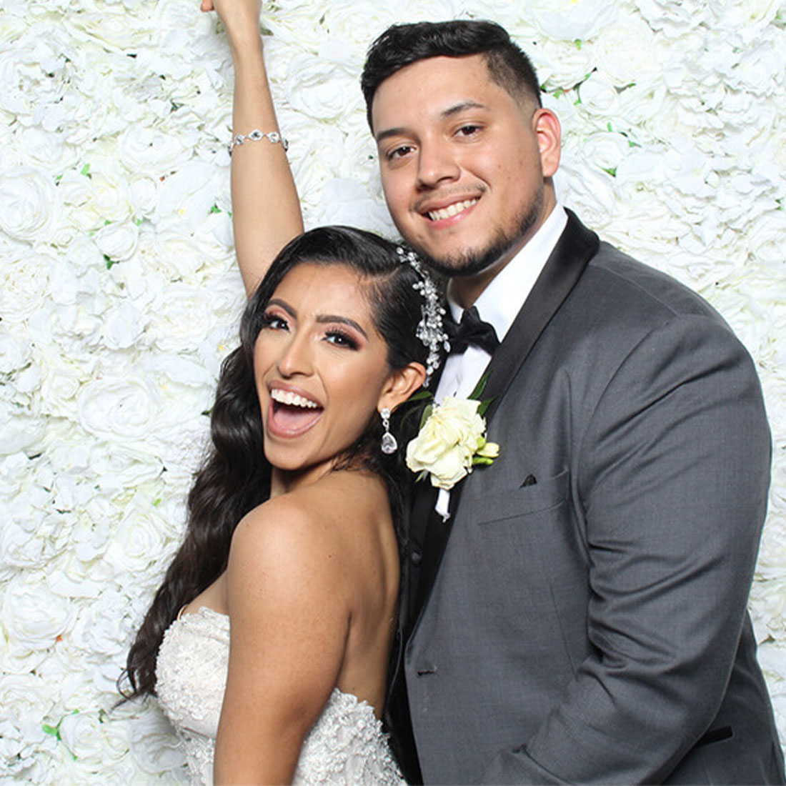 Flower Wall Rental with couple posing for photo booth rental